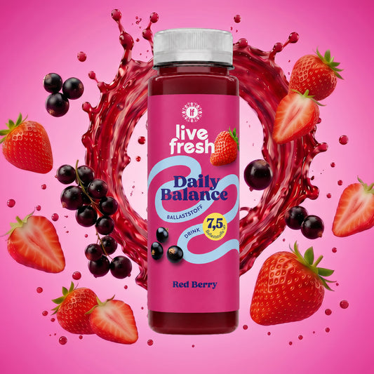 LiveFresh Daily Balance Fiber Source Drink Red Berry with strawberries and black currants and a swirl of juice in the background